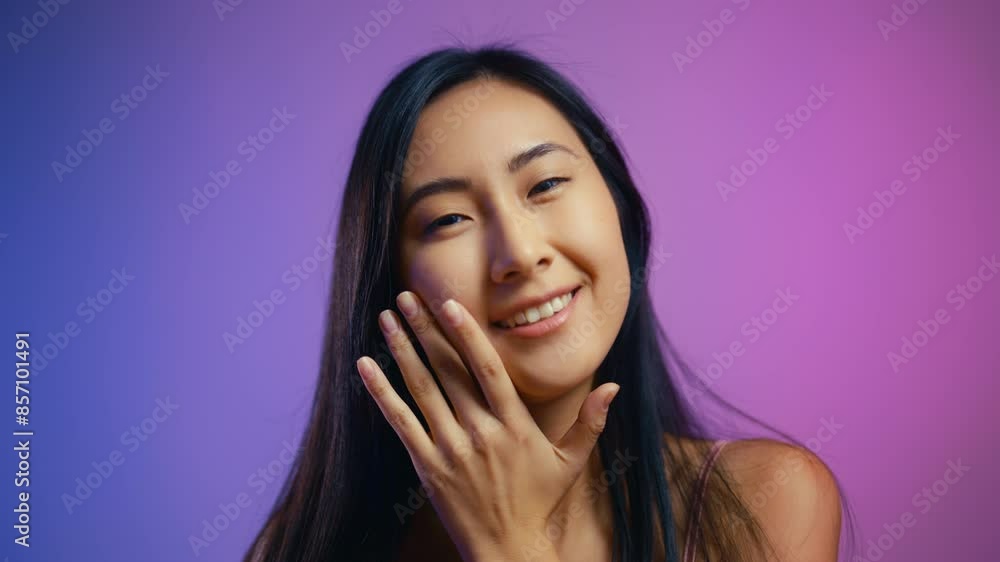 Happy Asian woman pleased with her face skincare routine and beauty procedures Happy Asian woman pleased with her face skincare routine and beauty procedures