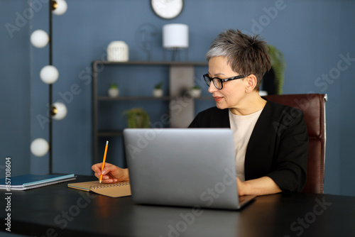 Professional woman working on her laptop, blending modern technology with a dedicated corporate lifestyle.