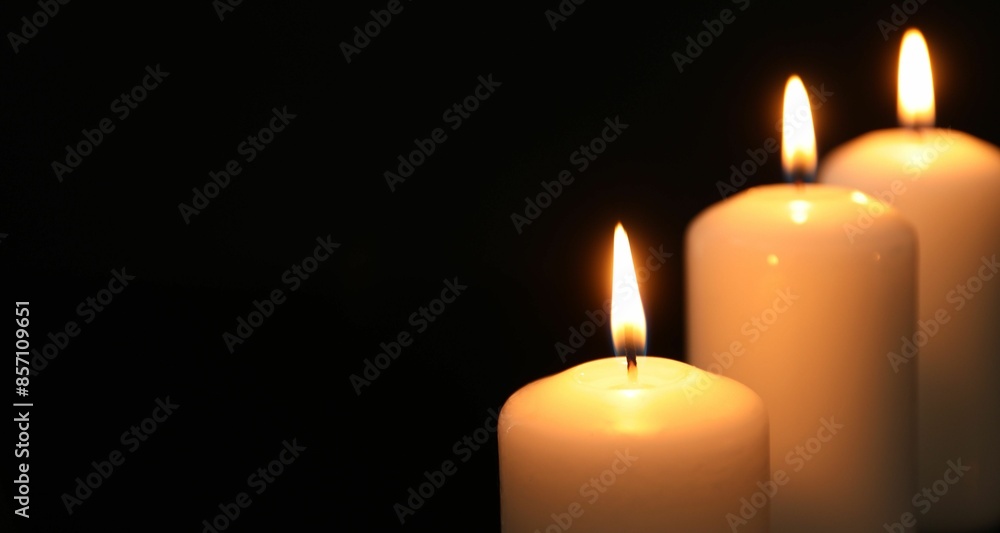 Many burning candles on black background, closeup. Space for text Many burning candles on black background, closeup. Space for text