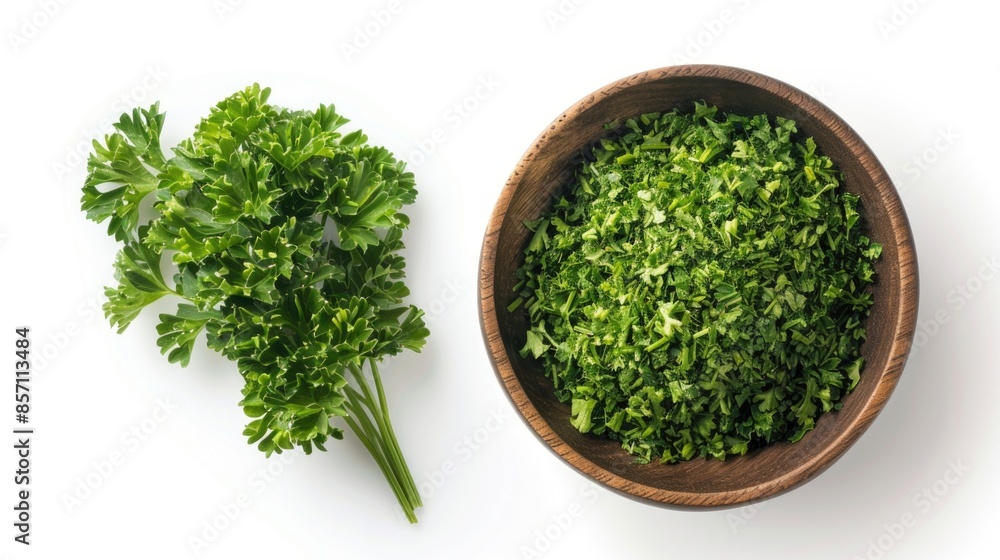 A wooden bowl filled with various green vegetables and a bunch of fresh parsley A wooden bowl filled with various green vegetables and a bunch of fresh parsley