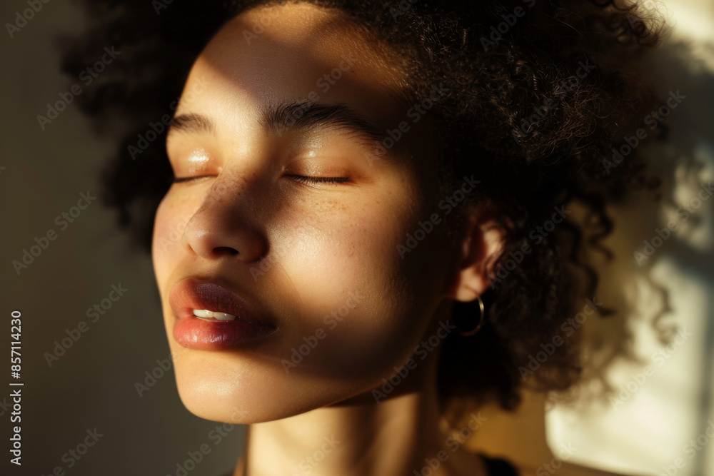 A serene portrait of a person with eyes closed, basking in the warm rays of sunlight filtering through, capturing a moment of peace.