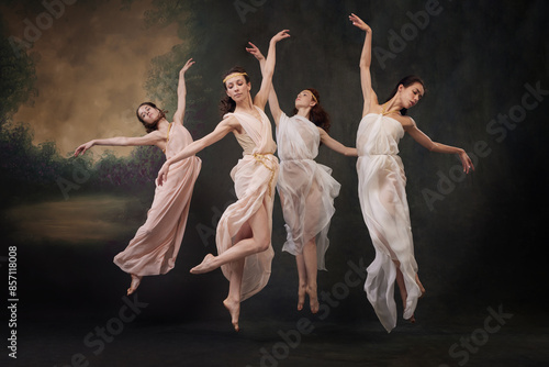 Foto Beautiful girls, ballerinas jumping gracefully in motion, as mythological muses against vintage studio background