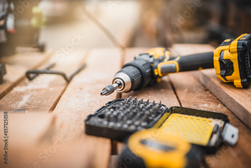 Wallpaper Mural Electric cordless screwdriver. Screwdriver with spare attachments. Iron screw, screws as a background, wood screw, concept industry. Torontodigital.ca