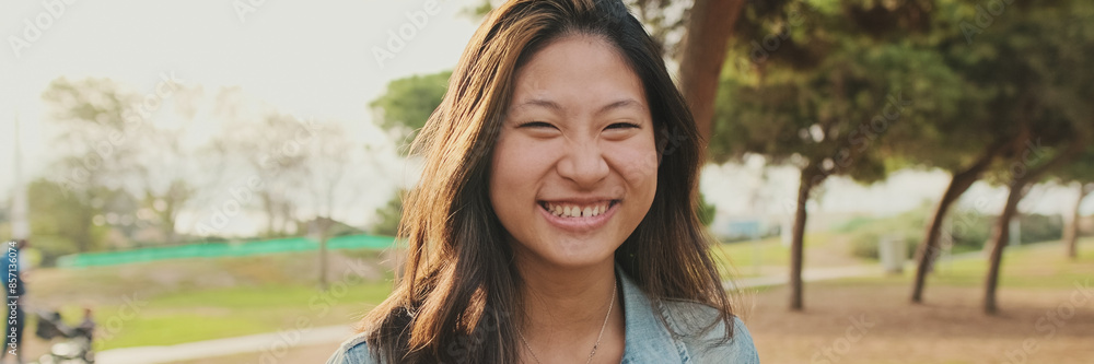 Close up, young woman posing at camera while standing in park, Looking at camera, panorama Close up, young woman posing at camera while standing in park, Looking at camera, panorama