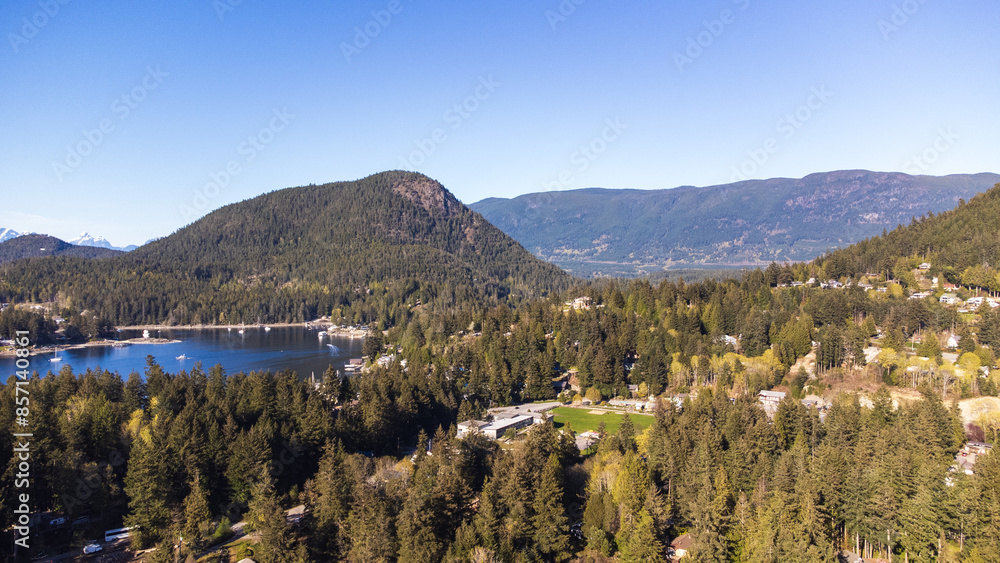 Aerial view of Gerrans Bay. Forested Islands sit in the water. Rolling mountains stretch along the horizon Aerial view of Gerrans Bay. Forested Islands sit in the water. Rolling mountains stretch along the horizon
