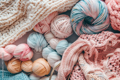 A colorful assortment of yarn balls and knitted fabrics in pastel shades, perfect for crafting, knitting, and crochet projects.