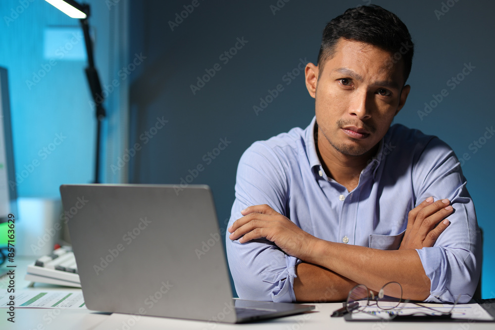 Serious businessman working overtime in the office. Serious businessman working overtime in the office.