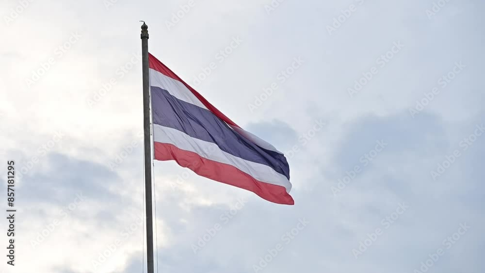 A Thailand national flag blowing by wind against overcast sky. A Thailand national flag blowing by wind against overcast sky.