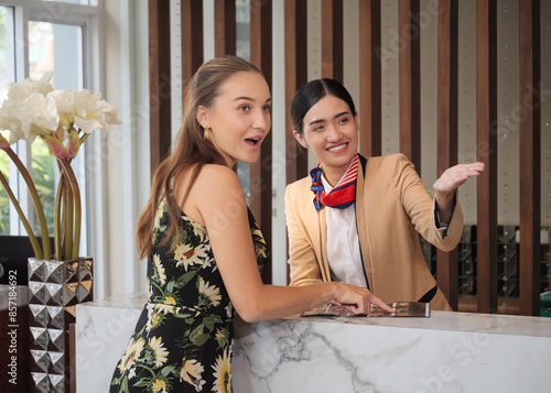 The charming young lady was pleased with the receptionist's advice on the hotel's services to the guests.