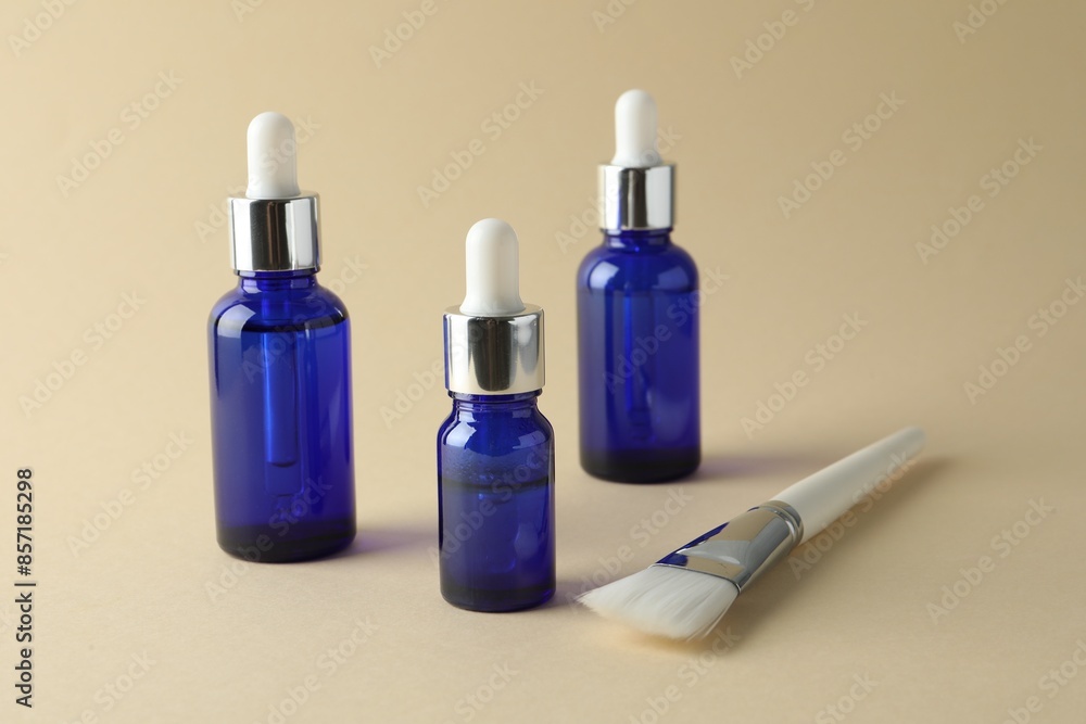 Bottles of chemical peel and brush on beige background. Peeling procedure Bottles of chemical peel and brush on beige background. Peeling procedure
