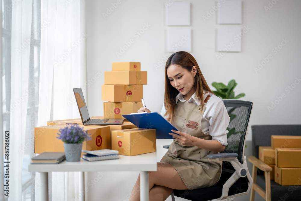 A woman is sitting at a desk with a laptop and a clipboard A woman is sitting at a desk with a laptop and a clipboard