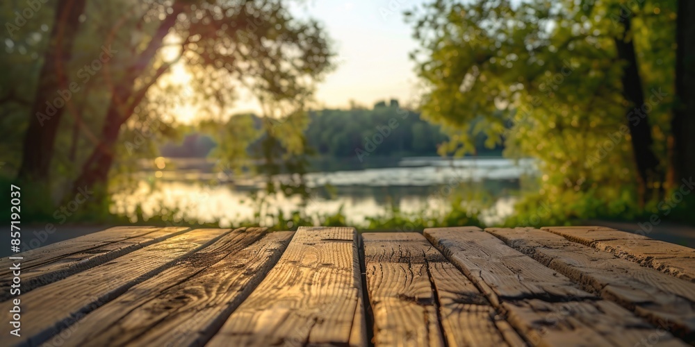 A wooden table sits in front of a serene lake with calm waters and surrounding nature A wooden table sits in front of a serene lake with calm waters and surrounding nature