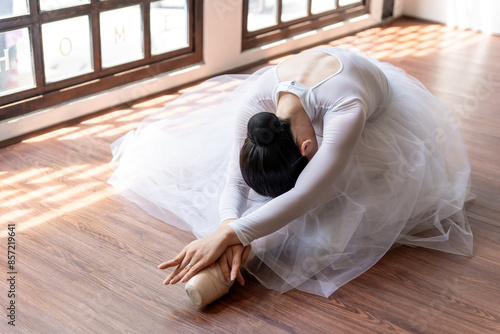 Asian girl ballet dancer creative performance with white skirt demonstrating dancing skill Young graceful  ballerina training exercise body practice on studio wellness Beauty classic ballet