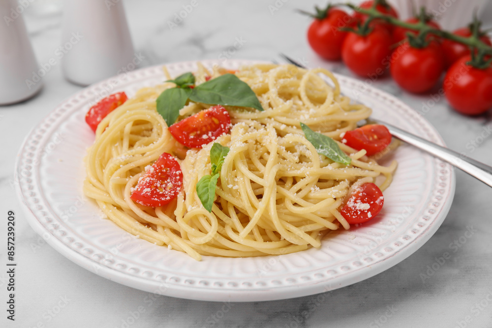 Tasty pasta with tomato, cheese and fork on white marble table, closeup Tasty pasta with tomato, cheese and fork on white marble table, closeup