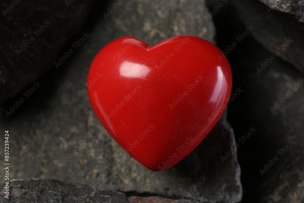 One red decorative heart on stones, closeup One red decorative heart on stones, closeup