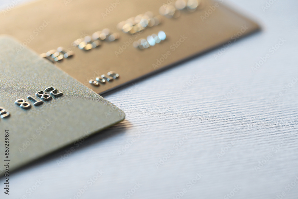 Two credit cards on light background, closeup Two credit cards on light background, closeup