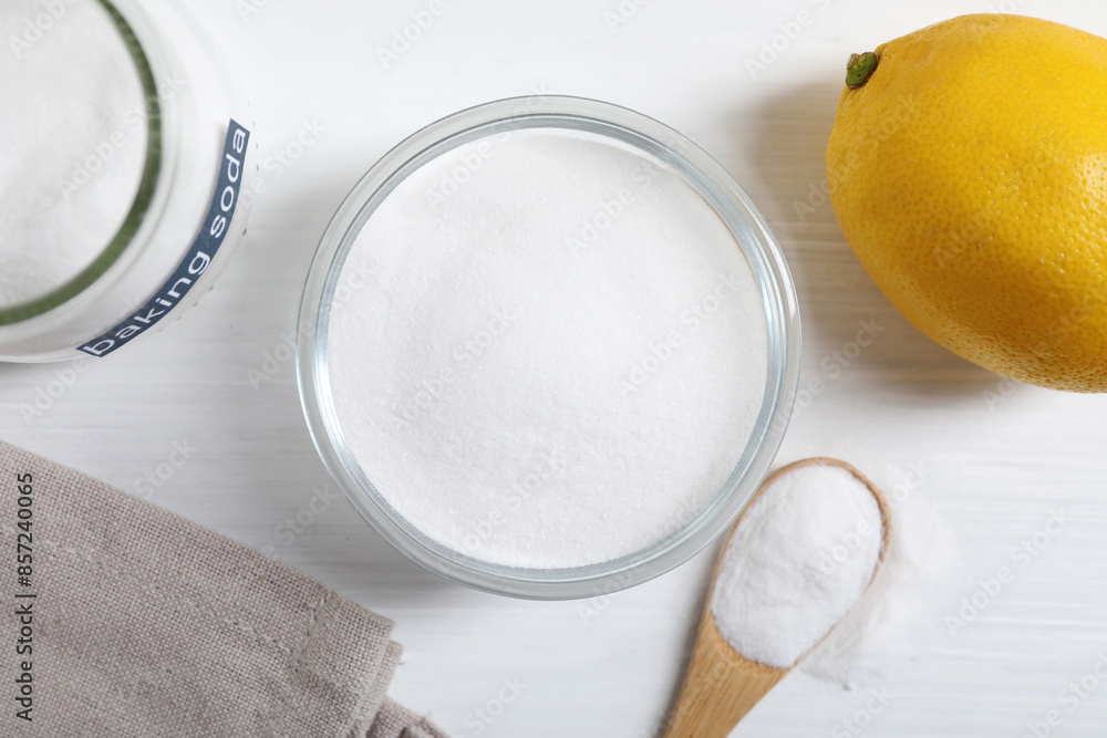 Baking soda and lemon on white wooden table, flat lay Baking soda and lemon on white wooden table, flat lay