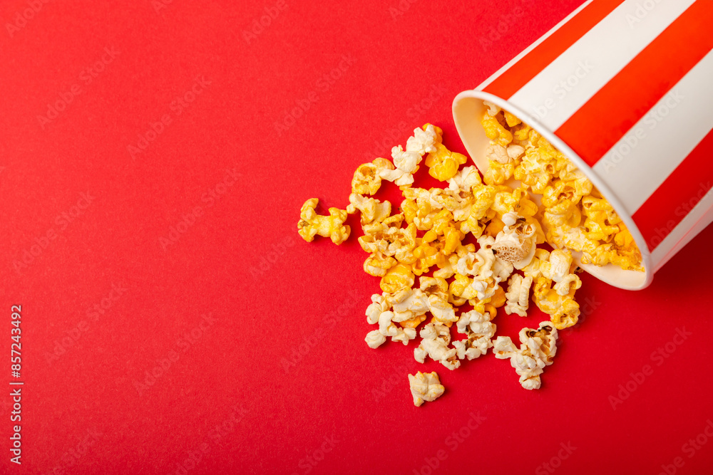 Popcorn box. Red and white striped buckets of popcorn on background. Cinema and entertainment concept. Movie night with popcorn. Cheesy popcorn. Delicious appetizer, snack. Place for text. Popcorn box. Red and white striped buckets of popcorn on background. Cinema and entertainment concept. Movie night with popcorn. Cheesy popcorn. Delicious appetizer, snack. Place for text.