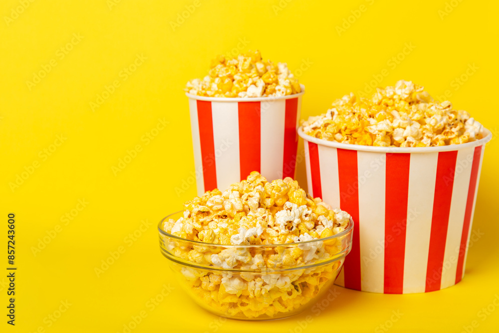 Popcorn box. Red and white striped buckets of popcorn on background. Cinema and entertainment concept. Movie night with popcorn. Cheesy popcorn. Delicious appetizer, snack. Place for text. Popcorn box. Red and white striped buckets of popcorn on background. Cinema and entertainment concept. Movie night with popcorn. Cheesy popcorn. Delicious appetizer, snack. Place for text.
