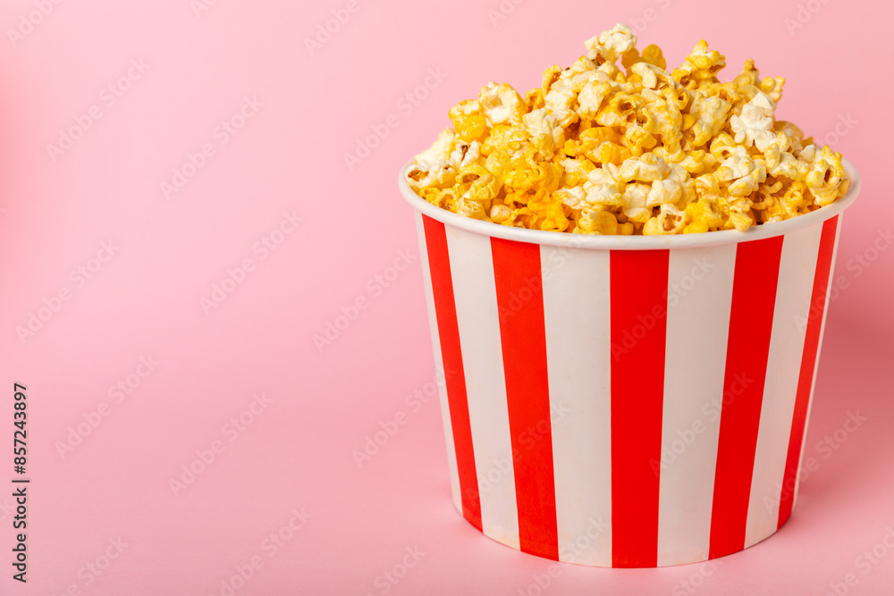 Popcorn box. Red and white striped buckets of popcorn on background. Cinema and entertainment concept. Movie night with popcorn. Cheesy popcorn. Delicious appetizer, snack. Place for text. Popcorn box. Red and white striped buckets of popcorn on background. Cinema and entertainment concept. Movie night with popcorn. Cheesy popcorn. Delicious appetizer, snack. Place for text.
