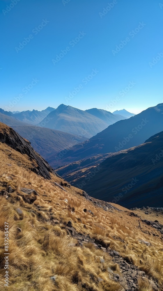 Naklejka premium Mountain landscape on a clear day with blue sky, panoramic view. Nature and tranquility concept