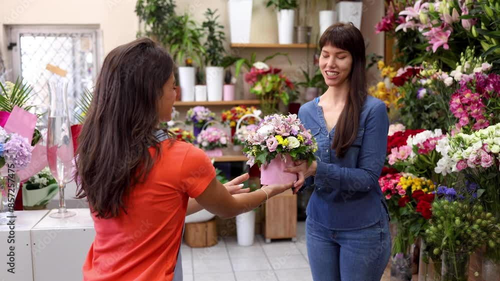 Young florist helping her customer with the choice Young florist helping her customer with the choice