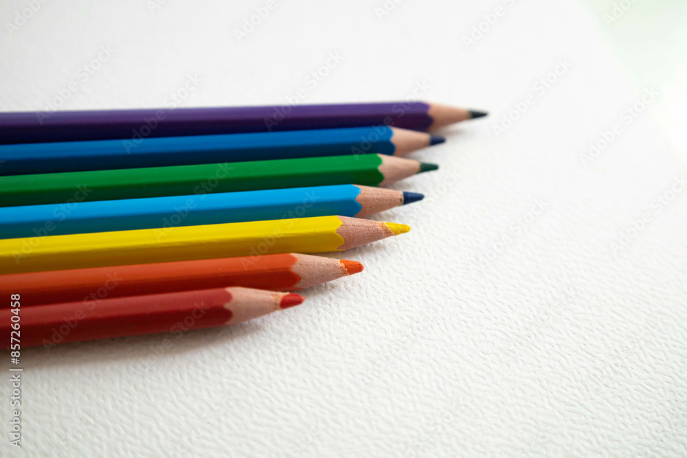 Pencils in rainbow colors on a white sheet Pencils in rainbow colors on a white sheet