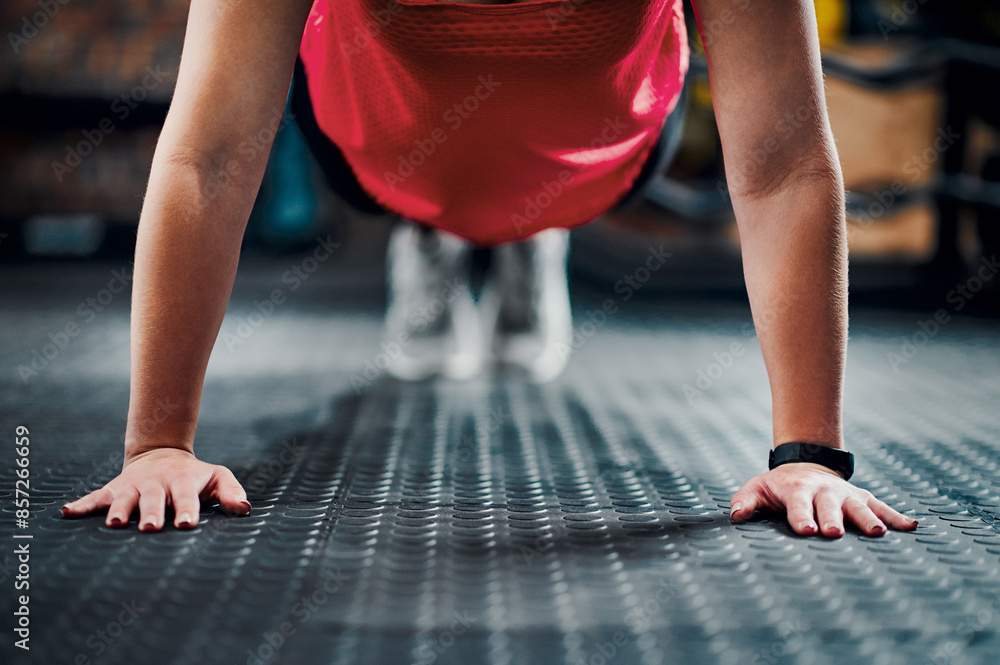 Naklejka premium Woman, pushup and hands on floor in gym, training and strong muscles or exercise in health club or center. Body, wellness and performance or arm workout, bodybuilder and active or sport challenge