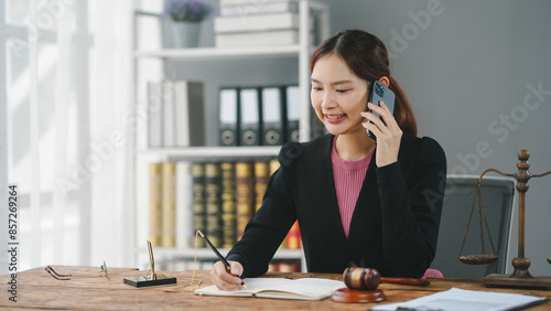 Εκτύπωση καμβά Businesswoman talking on phone and taking notes in office with bookshelf