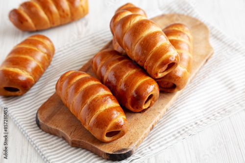 Photography Homemade Kolache Rolls on a rustic wooden board, side view.