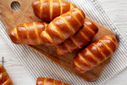 Photography Homemade Kolache Rolls on a rustic wooden board, top view.