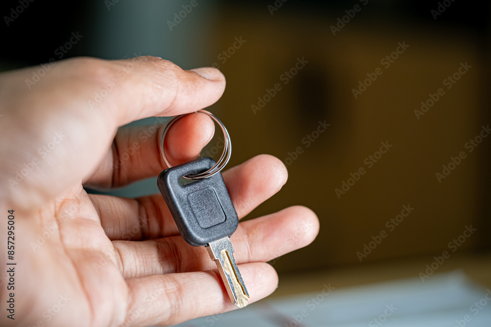 Hand holding car key close-up
