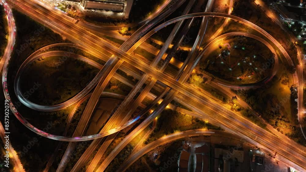 Financial technology, energy power, beautiful top view time-lapse of car traffic at roundabout lane and buildings. 4K drone aerial zoom out. Urban cityscape concept or abstract of advanced innovation. Financial technology, energy power, beautiful top view time-lapse of car traffic at roundabout lane and buildings. 4K drone aerial zoom out. Urban cityscape concept or abstract of advanced innovation.