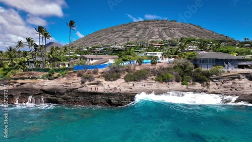 Surfer catching a wave at China Walls in Portlock, Hawaii Kai on Oahu, Hawaii photo