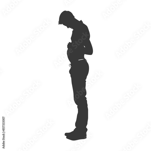 Silhouette of pensive man looking down, hand on stomach.