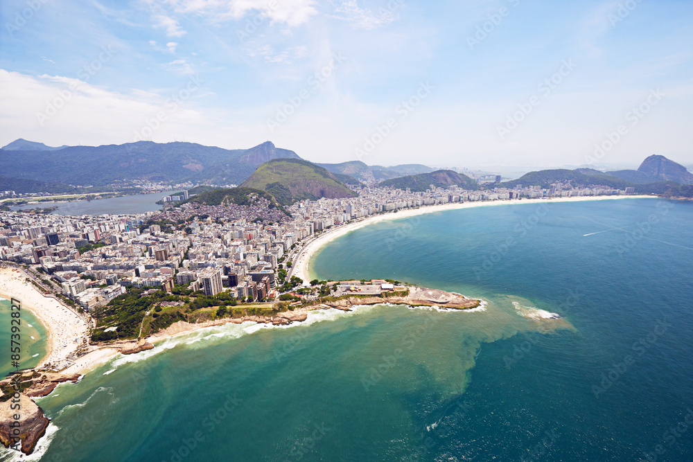 Naklejka premium Aerial view, ocean and buildings in city, outdoor and architecture in Brazil, tourism and destination. Morning, above and travel in Rio De Janeiro, water and explore in vacation and mountain in sea