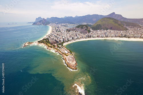 Aerial view, ocean and buildings in city, travel and architecture in Brazil, tourism and destination. Morning, above and outdoorl in Rio De Janeiro, water and explore in vacation and mountain in sea photo