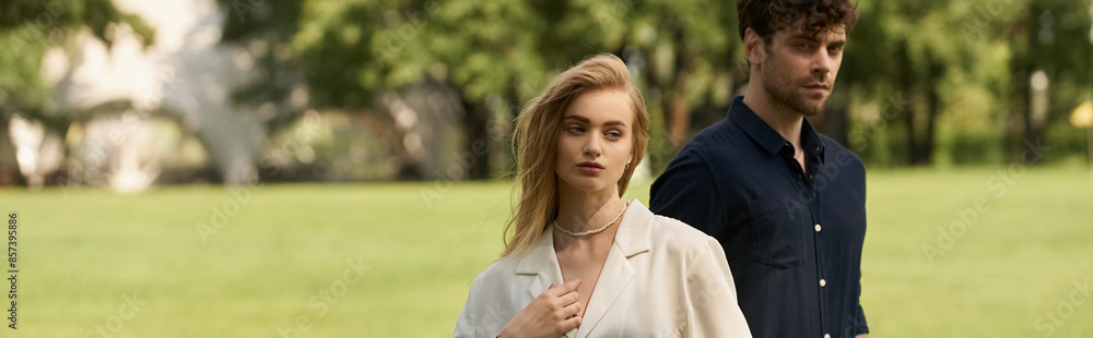 A young couple exudes elegance in a lush green field, embodying old money luxury and a rich lifestyle. A young couple exudes elegance in a lush green field, embodying old money luxury and a rich lifestyle.