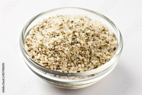 Hemp hearts seeds in glass bowl closeup on white background dietary supplement