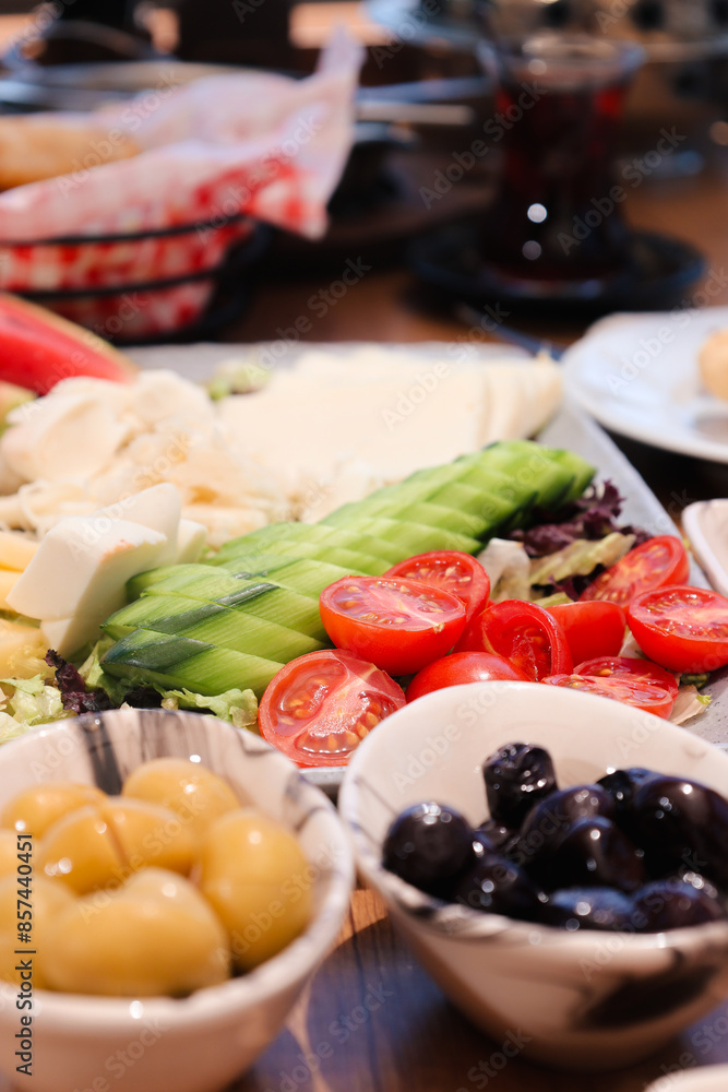 A colorful Turkish breakfast spread with a variety of foods including vegetables, cheese, and olives, perfect for a healthy start to the day. A colorful Turkish breakfast spread with a variety of foods including vegetables, cheese, and olives, perfect for a healthy start to the day.