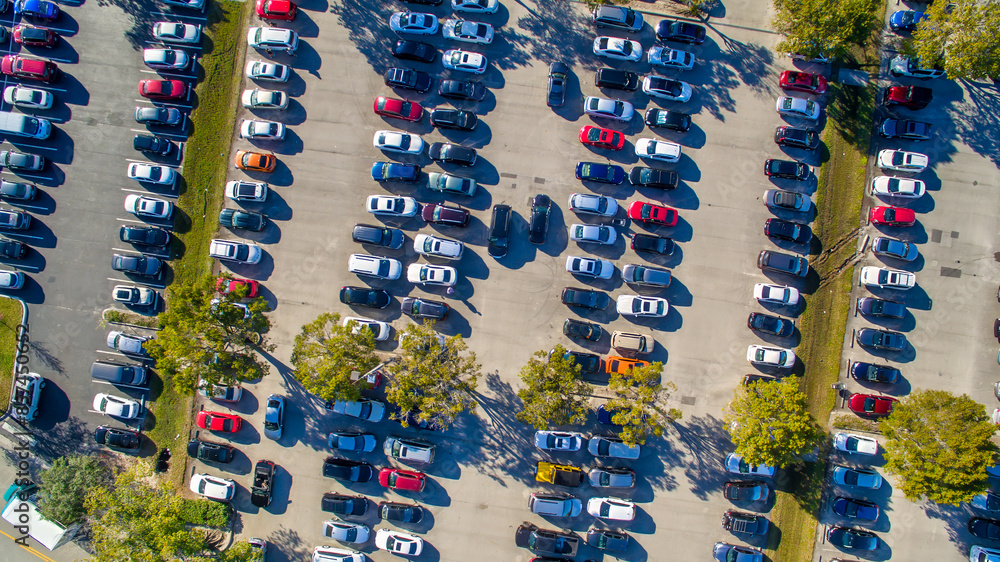 Fototapeta premium Aerial view of an full car parking along a mall center