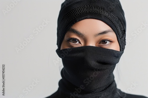 A person wearing a black hat and mask, suitable for use in mystery or detective themes