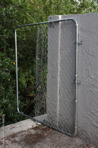 Vandalized Chain Link Fence Overhanging Sea Wall photo