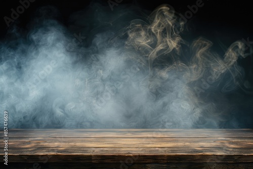 An empty wooden table with smoke floating up on a dark background.
