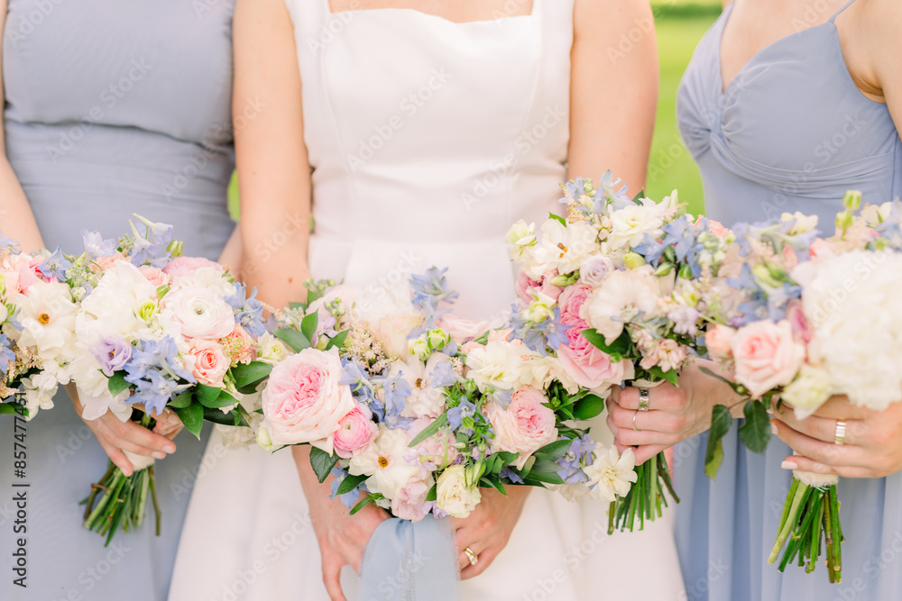 Bride and bridesmaids are holding wearing pretty wedding bouquets. Bride and bridesmaids are holding wearing pretty wedding bouquets.