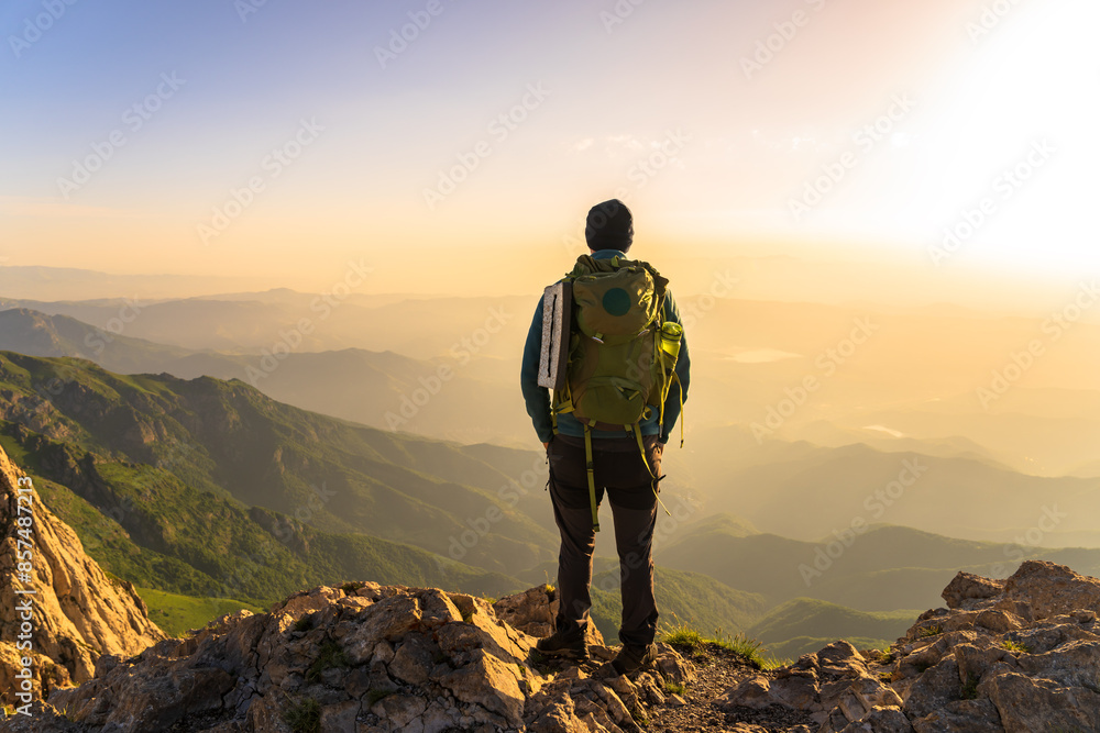 Mountaineer with backpack on top of mountain, travel, mountaineering concept Mountaineer with backpack on top of mountain, travel, mountaineering concept