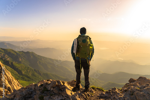 Wallpaper Mural Mountaineer with backpack on top of mountain, travel, mountaineering concept Torontodigital.ca