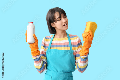 Young woman with sponge and...