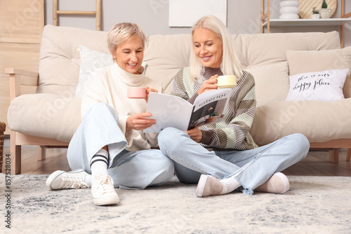 Mature women with cups of t...