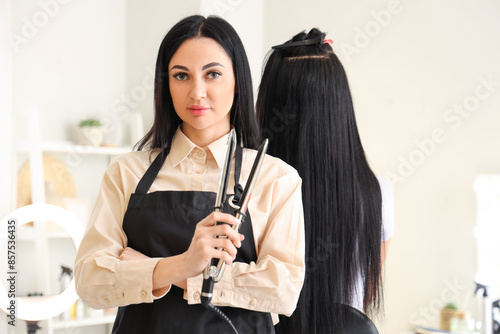 Female hairdresser with iro...